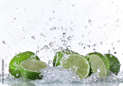 Fototapeta na wymiar Limes with water splash