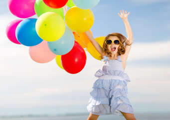 Wall Mural - happy jumping girl with colorful balloons