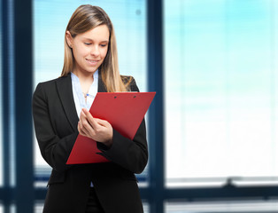 Poster - Female manager writing on some documents