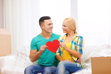 Sticker - smiling couple with red heart on sofa in new home