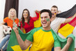 © gpointstudio - Excited brazilian man with her friends cheering football match