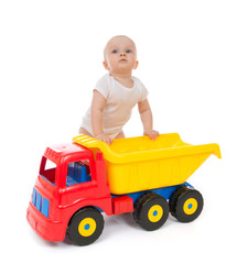 Wall Mural - Infant child baby boy toddler with big toy car truck