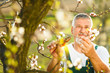 © lightpoet - Portrait of a handsome senior man gardening in his garden