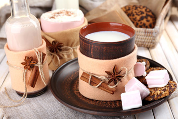 Fototapete - Mug of hot drink decorated in felt on wooden table
