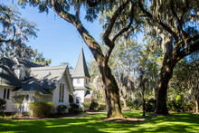 White Church Under Spanish Moss And Green Lawn