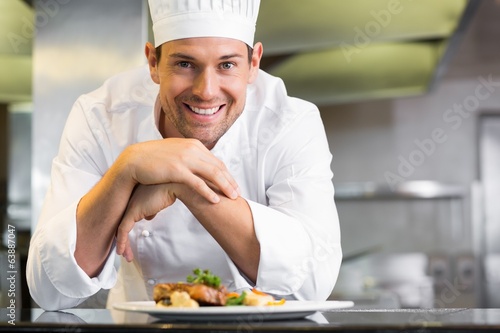 Fotografie, Obraz Smiling male chef with cooked food in kitchen