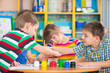© spass - Cute children drawing with colorful paints at kindergarten