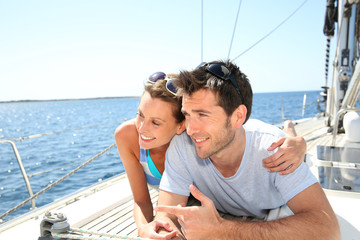 Wall Mural - Couple relaxing on sailboat deck