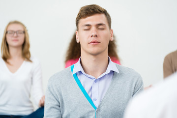 Wall Mural - young man, meditating with closed eyes