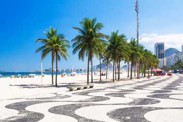 Fototapete - Copacabana with palms and mosaic of sidewalk in Rio de Janeiro