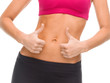 © Syda Productions - close up of female abs and hands showing thumbs up