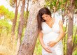 Pregnant girl in summer forest