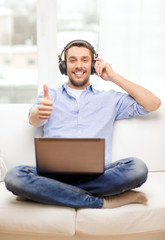 Poster - smiling man with laptop and headphones at home