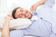 © Syda Productions - smiling young man lying on sofa at home