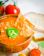 Canvas Print - Hot and spicy fresh made Mexican chili soup on rustic background