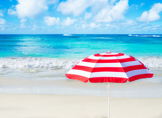 Wall Mural - Beach umbrella by the ocean