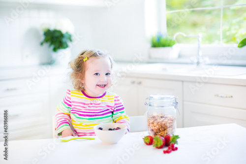 Beautiful Toddler Girl With Curly Hair Wearing A Colorful Shirt