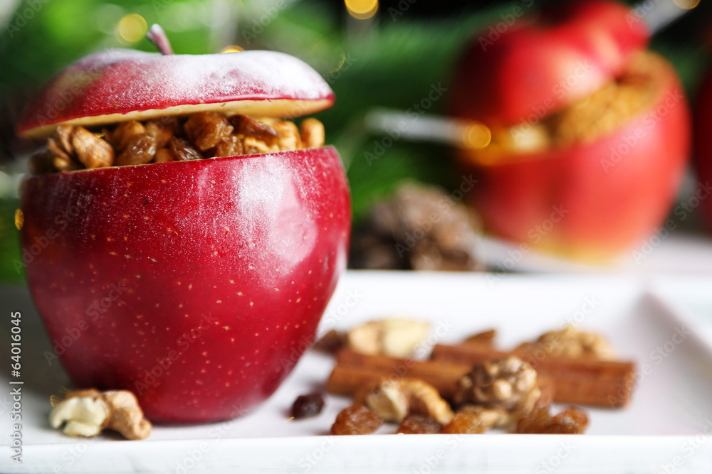Stuffed Christmas apples with nuts and raisins on table close