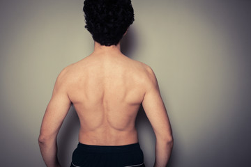 Wall Mural - Rear view of athletic young man