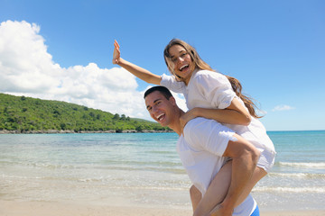 Wall Mural - happy couple have fun on the beach