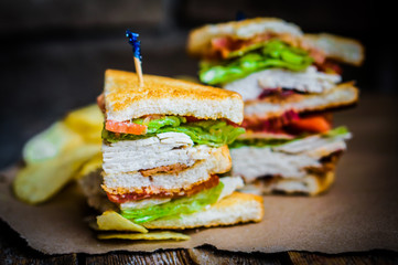 Club sandwich on rustic wooden background