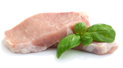 Canvas Print - Raw meat steaks with basil isolated on white