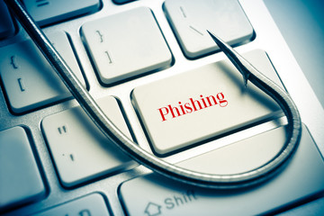 Wall Mural - phishing / fish hook on computer keyboard