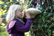 © endostock - Little caucasian girl examining large Tinder fungus