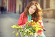 © ZoomTeam - sensual brunette girl sitting on bicycle with some spring flower