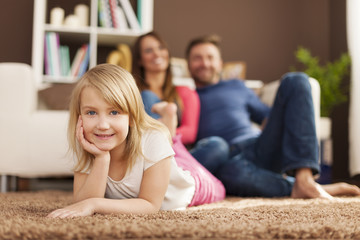 Poster - Portrait of smiling girl relaxing with her parents at home