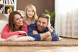 © gpointstudio - Portrait of loving family on carpet
