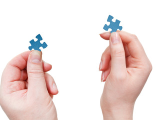 Wall Mural - male and female hands with little puzzle pieces