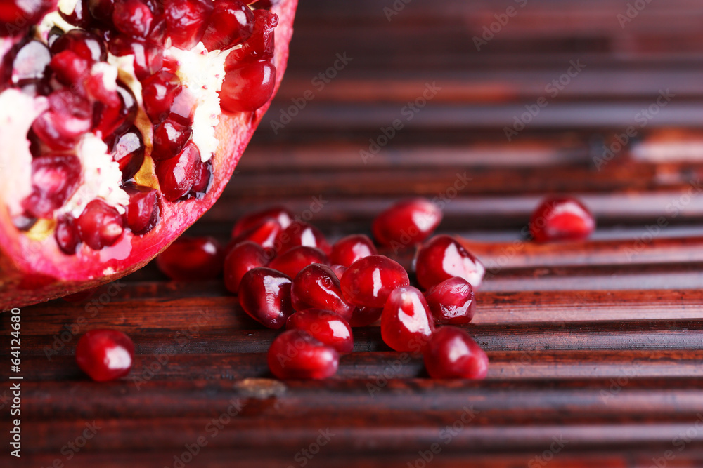Ripe pomegranate on bamboo mat background