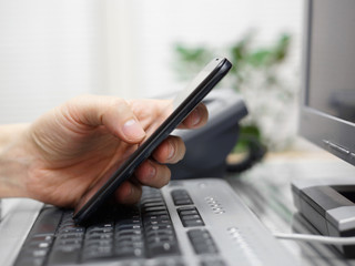 businessman working in office with mobile phone and computer