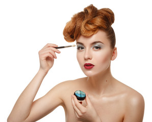 Beauty portrait of pretty woman with brush for makeup