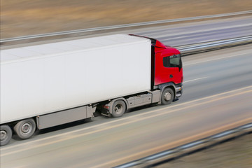 trailer with red cabin goes on the highway