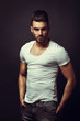 © djile - Handsome man posing in studio on dark background