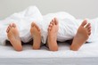 © WavebreakMediaMicro - Couples feet sticking out from under duvet