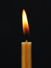 Burning Candle On Black Background