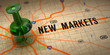 © tashatuvango - New Markets - Green Pushpin on a Map Background.