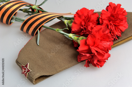 Poster Military cap, carnations tied with Saint George ribbon on gray