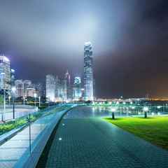 Fototapete - pathway in the night with modern city background