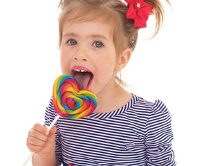 little girl licking a lollipop.