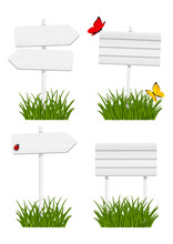 Set Of Wooden Signboards In Green Grass