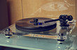 Modern expensive vinyl turntable playing music.