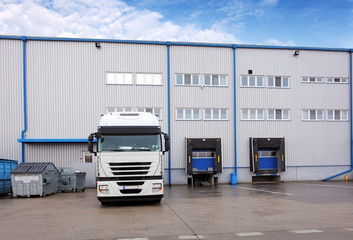 Shipping cargo truck at warehouse building