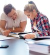 © Nejron Photo - Young students couple preparing for exams behind table