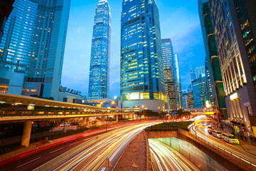 Road tunnels light trails on modern city buildings backgrounds i