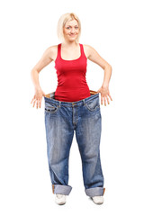 Poster - Woman standing in a pair of oversized jeans