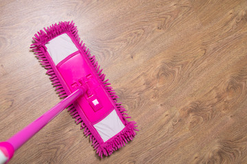 Wall Mural - cleaning wooden parquet floor with pink mop